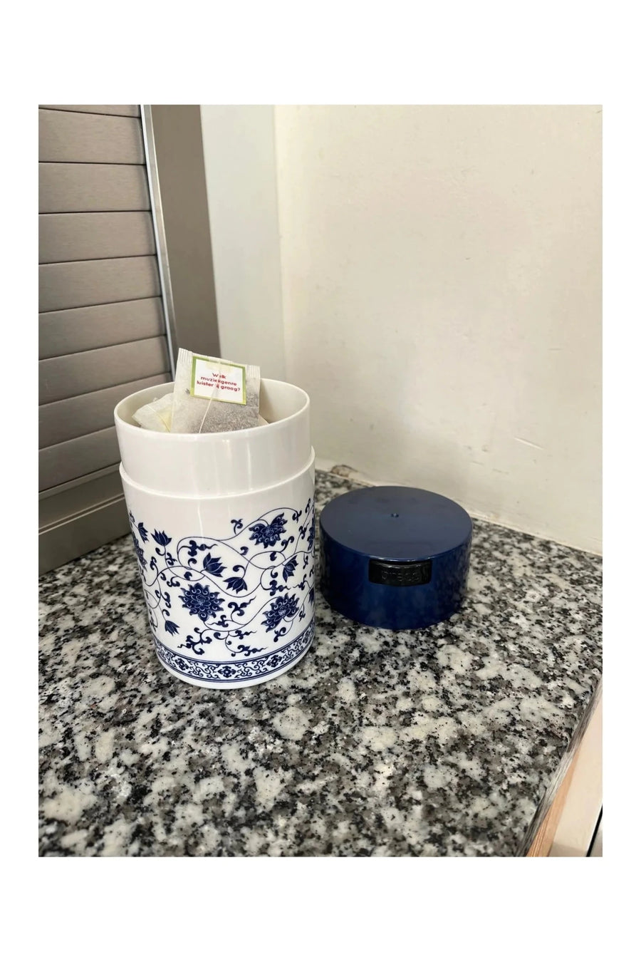 Boîtes TightVac sur un plan de travail en granit, motif floral bleu à côté du bleu foncé